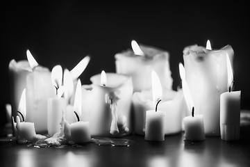 Image showing Candles glowing against dark background