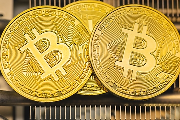 Image showing Physical shiny bitcoin agains dark background