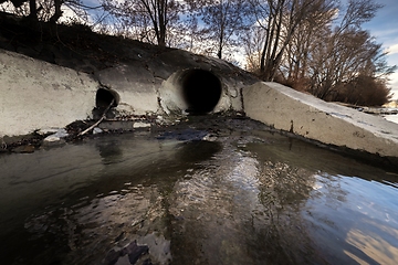 Image showing Large sewage tunnel with filth flowing out