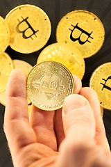 Image showing Physical bitcoin held in hands closeup