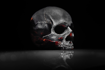 Image showing Spooky dark black skull aginast dark background