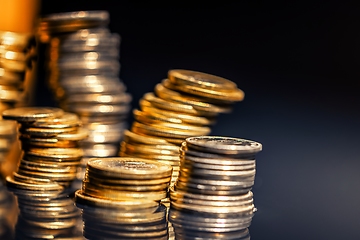 Image showing Large pile of coins against dark background