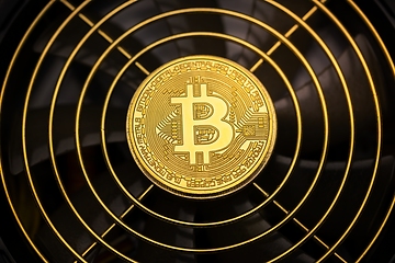 Image showing Physical shiny bitcoin agains dark background