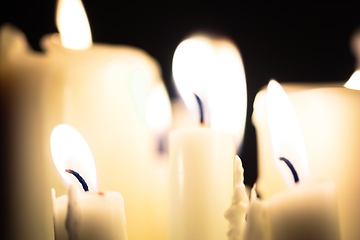 Image showing Candles glowing against dark background