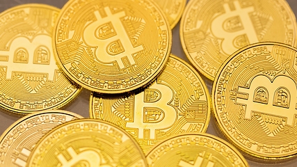 Image showing Physical shiny bitcoin agains dark background