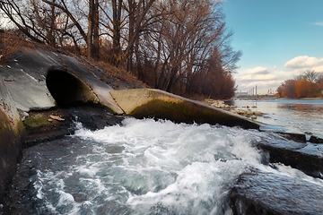 Image showing Large sewage tunnel with filth flowing out