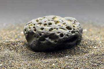 Image showing Smoke whirling around small meteorite stone