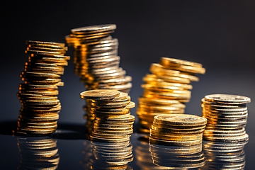 Image showing Large pile of coins against dark background