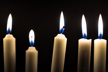 Image showing Candles glowing against dark background