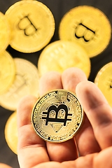 Image showing Physical bitcoin held in hands closeup