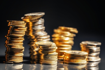 Image showing Large pile of coins against dark background