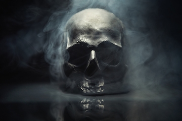 Image showing Spooky dark black skull aginast dark background