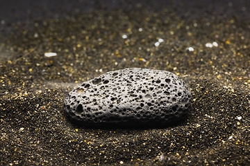 Image showing Smoke whirling around small meteorite stone