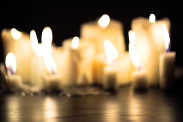 Image showing Candles glowing against dark background