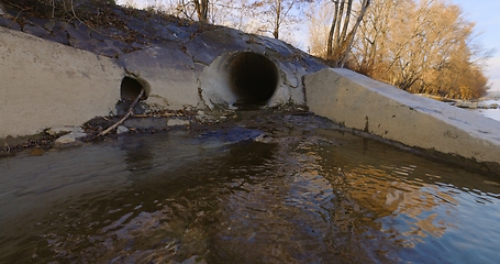 Image showing Large sewage tunnel with filth flowing out