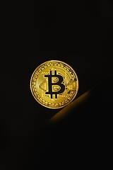 Image showing Physical shiny bitcoin agains dark background