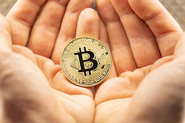 Image showing Physical bitcoin held in hands closeup