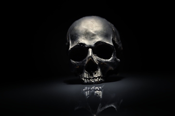 Image showing Spooky dark black skull aginast dark background