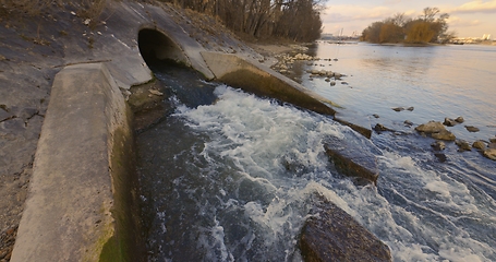 Image showing Large sewage tunnel with filth flowing out