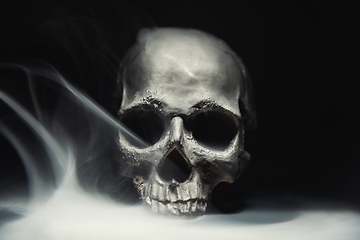 Image showing Spooky dark black skull aginast dark background