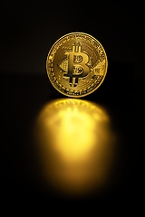 Image showing Physical shiny bitcoin agains dark background