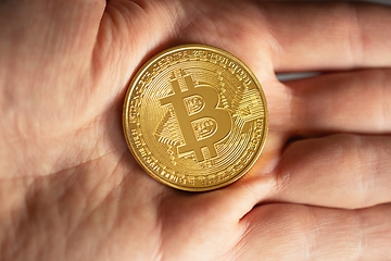 Image showing Physical bitcoin held in hands closeup