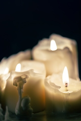 Image showing Candles glowing against dark background