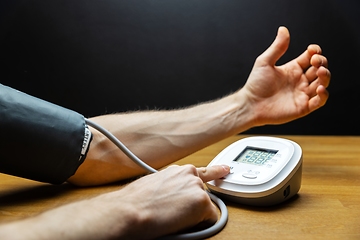 Image showing Man measuring blood pressure closeup