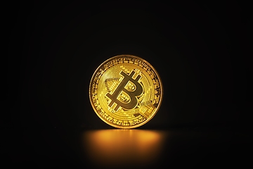 Image showing Physical shiny bitcoin agains dark background