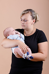 Image showing Loving mother embracing her baby