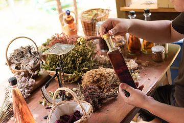 Image showing potion bottle in hand of herbalist