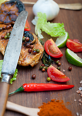 Image showing wood fired hoven cooked chicken breast on wood board 