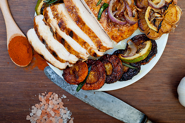 Image showing roasted grilled BBQ chicken breast with herbs and spices 