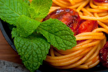 Image showing italian spaghetti pasta and tomato with mint leaves 