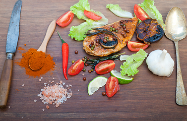 Image showing wood fired hoven cooked chicken breast on wood board 