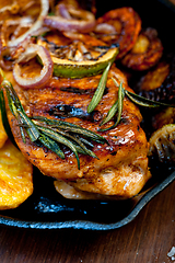 Image showing roasted grilled BBQ chicken breast with herbs and spices 