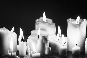 Image showing Candles glowing against dark background