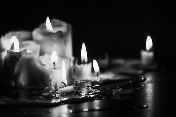 Image showing Candles glowing against dark background