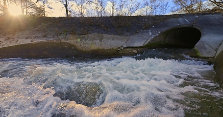 Image showing Large sewage tunnel with filth flowing out