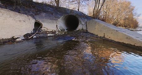 Image showing Large sewage tunnel with filth flowing out