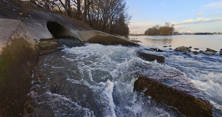 Image showing Large sewage tunnel with filth flowing out