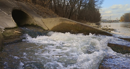 Image showing Large sewage tunnel with filth flowing out