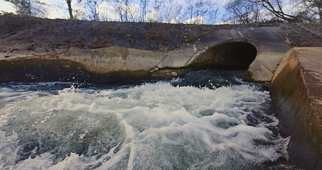 Image showing Large sewage tunnel with filth flowing out