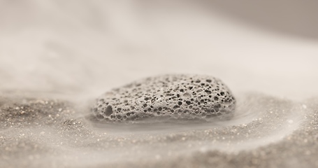 Image showing Smoke whirling around small meteorite stone