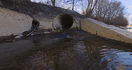 Image showing Large sewage tunnel with filth flowing out