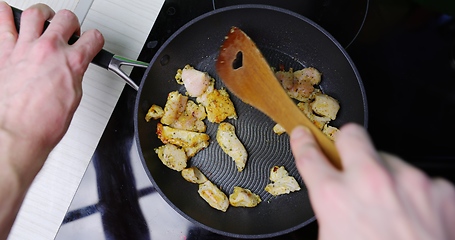 Image showing Preparing low fat fried chicken for dinner on induction