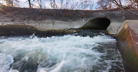 Image showing Large sewage tunnel with filth flowing out