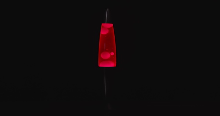 Image showing Red lava lamp aginast dark isolated background