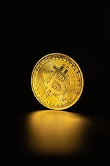 Image showing Physical shiny bitcoin agains dark background