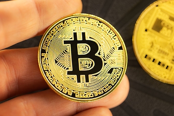 Image showing Physical bitcoin held in hands closeup